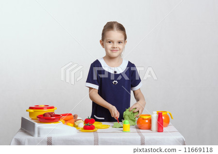 Little girl preparing food in the kitchen 11669118