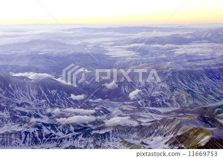 Andean mountains and sea of clouds emerging in light light just before dawn Andean mountains and sea of clouds emerging in light light just before dawn 11669753