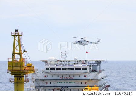 Helicopter landing on offshore oil rig 11670114