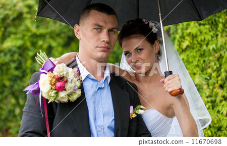 Just married couple hugging under umbrella 11670698