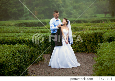 Just married couple walking at garden labyrinth 11670701