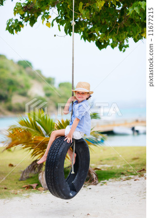 Little girl on tire swing 11677215
