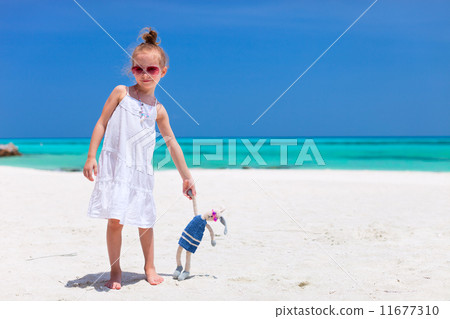 Little girl with toy at beach 11677310