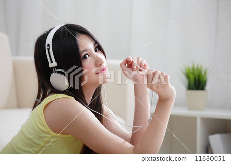 Young woman enjoying the music at home 11680051