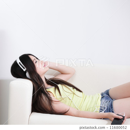 Young woman enjoying the music at home 11680052
