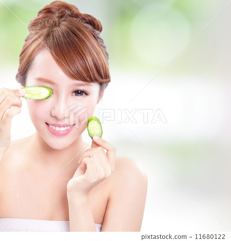 beautiful woman holding cucumber slices on face beautiful woman holding cucumber slices on face 11680122