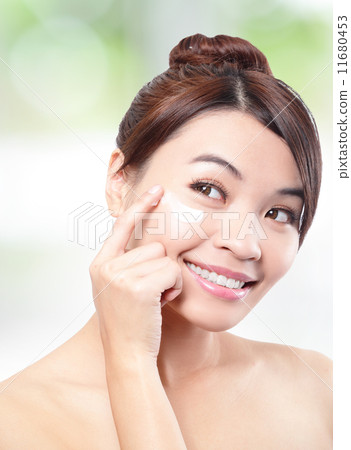 Beauty young woman applying cosmetic cream 11680453