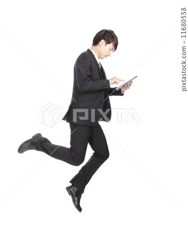 Business man jump touching tablet pc Business man jump touching tablet pc 11680558