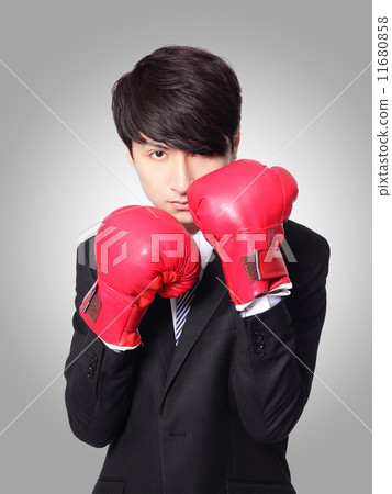 businessman ready punching with boxing gloves 11680858