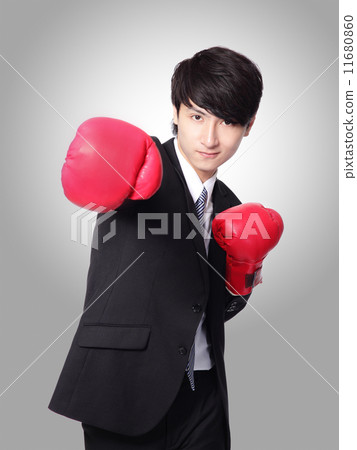 businessman punching and hitting with boxing gloves businessman punching and hitting with boxing gloves 11680860