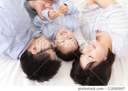 Happy family with children in bed 11680867
