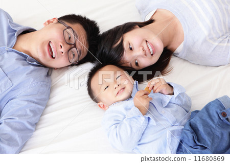 Happy family with children in bed 11680869