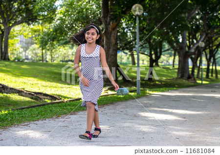 Smiling Young asian girl walking and hopping in the park Smiling Young asian girl walking and hopping in the park 11681084