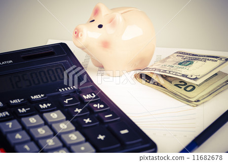 Business Charts with calculator, money, piggy box and pen Business Charts with calculator, money, piggy box and pen 11682678