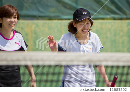 Two women playing tennis Two women playing tennis 11685202