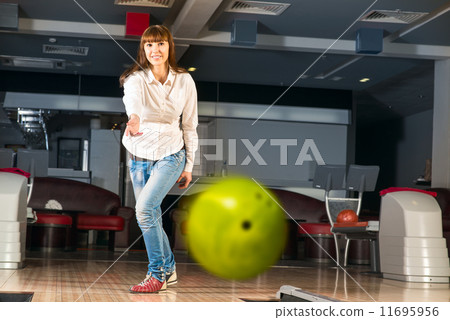 pleasant young woman throws a bowling ball pleasant young woman throws a bowling ball 11695956
