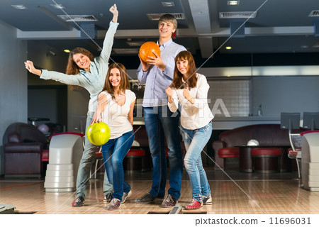 Group of young friends playing bowling 11696031