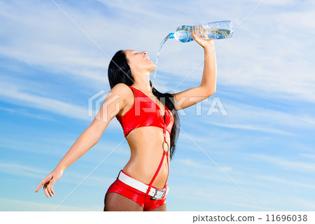 sport girl in red uniform with a bottle of water 11696038
