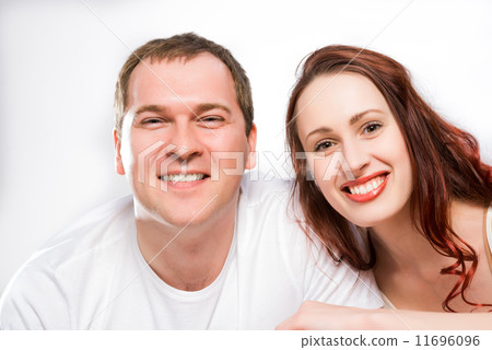 Young man and woman lying together in bed Young man and woman lying together in bed 11696096