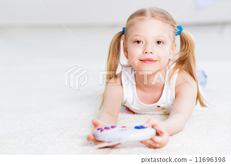 girl playing on a game console girl playing on a game console 11696398