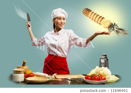 Asian female chef cuts pineapple Asian female chef cuts pineapple 11696401