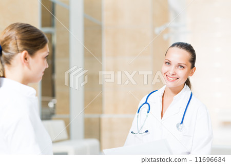 two doctors talking in the lobby 11696684