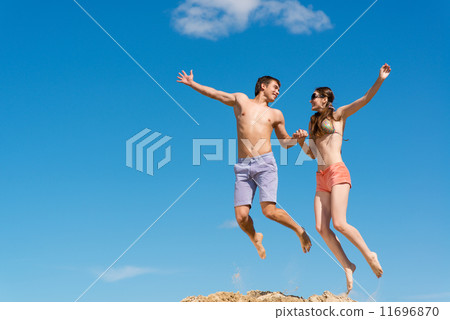 couple jumping together couple jumping together 11696870
