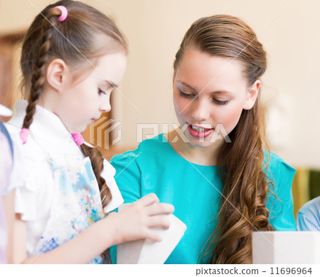 teacher talks to a schoolgirl 11696964