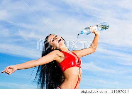 sport girl in red uniform with a bottle of water 11697034