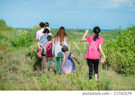 Family walking in the meadow with sunny day. 11702876
