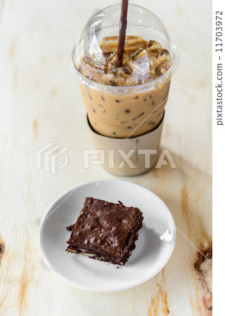 Fresh Homemade Chocolate Brownie and ice coffee against a backgr Fresh Homemade Chocolate Brownie and ice coffee against a backgr 11703972