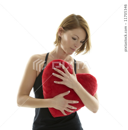 Woman with heart pillow 11705346