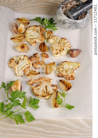 Warm appetizer of fried pieces of cauliflower with garlic and on Warm appetizer of fried pieces of cauliflower with garlic and on 11712401