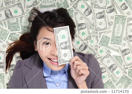 woman happy lying on money bed 11714170