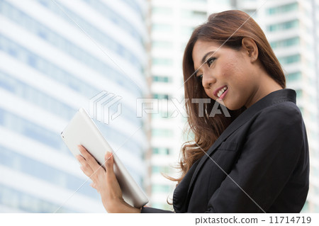 Businesswoman used tablet Businesswoman used tablet 11714719