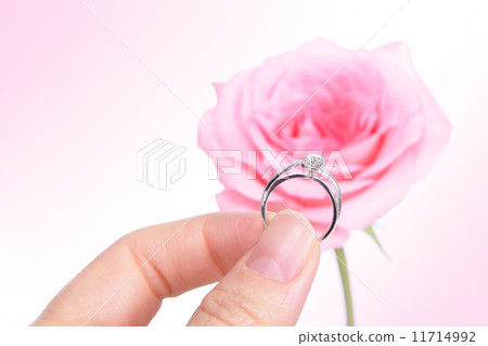 Hand holding romantic diamond wedding ring Hand holding romantic diamond wedding ring 11714992