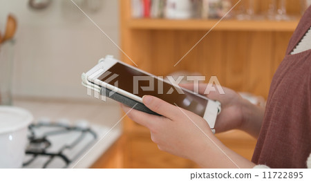 Tablet in kitchen Tablet in kitchen 11722895