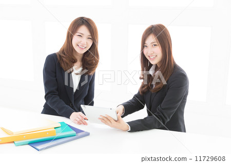 Two women business watching tablet business Two women business watching tablet business 11729608