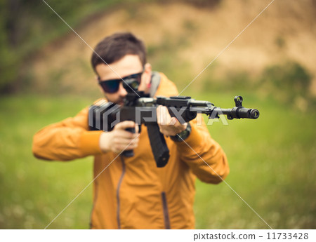 A man with an automatic rifle A man with an automatic rifle 11733428