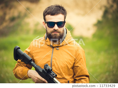 A man with an automatic rifle 11733429