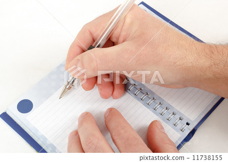 Close-up of hand beginning to write on notes 11738155