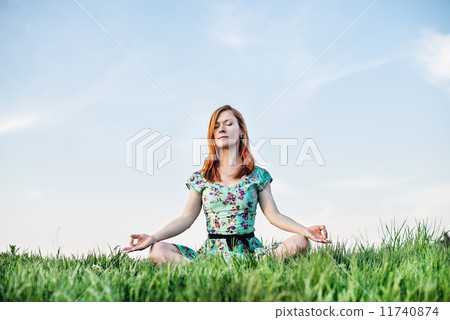 Pretty woman meditate in the park Pretty woman meditate in the park 11740874