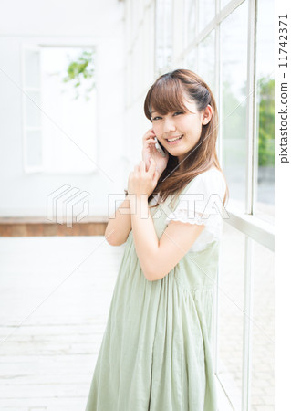 A woman using a mobile phone A woman using a mobile phone 11742371