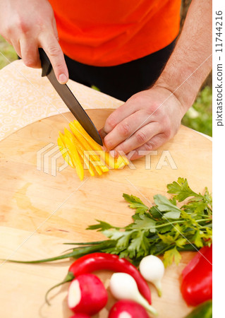 Man cutting vegetables Man cutting vegetables 11744216