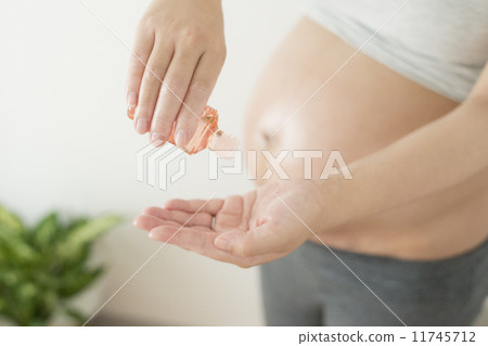 Pregnant women doing oil massage Pregnant women doing oil massage 11745712