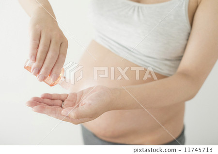 Pregnant women doing oil massage Pregnant women doing oil massage 11745713