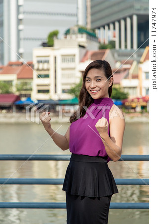 Asian businesswoman celebrating success 11747973