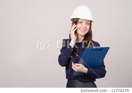 woman in hard hat talking to a customer on phone 11750274