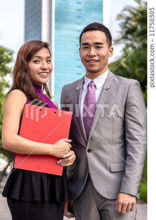 2 young and confident Asian business associates outdoor 11750305