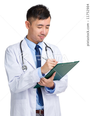 Male doctor writing on folder Male doctor writing on folder 11752984
